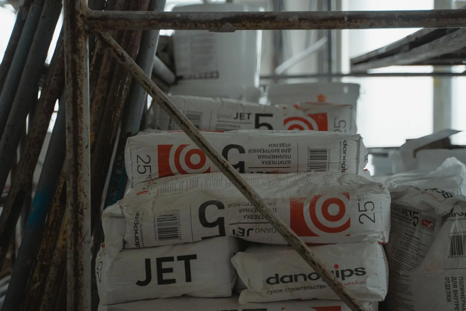 Sacks of filler stacked on a building site, their printed panels facing out